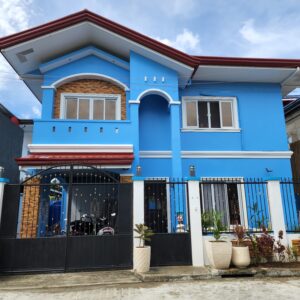 Stunning two-storey house in Maribago, LapuLapu City, with blue exterior, swimming pool, and modern amenities, for sale.